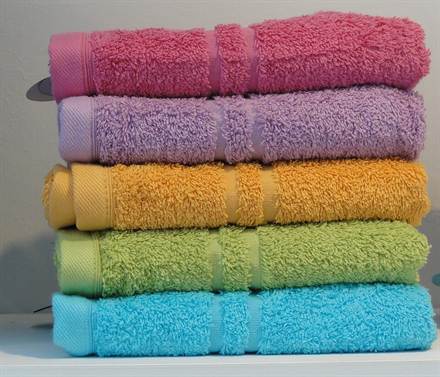 A neat stack of folded textiles, ready for protective packing